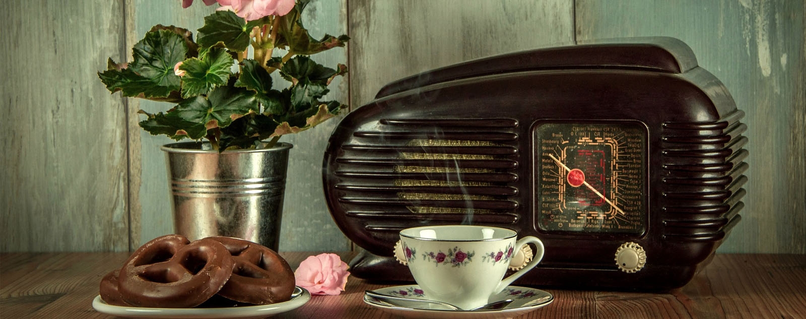portrait of vintage radio, vase with flowers, and tea things